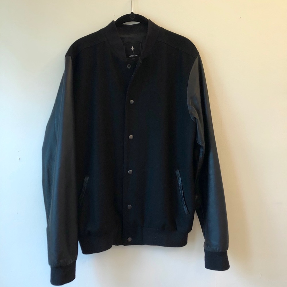 Men’s black bomber jacket with leather sleeves.